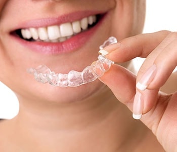 Woman putting in clear aligners