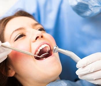 Young female patient getting her teeth examined