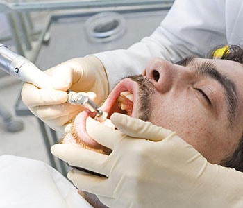 Male patient getting his gums treated