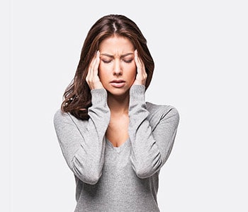 Young woman holding her head in pain