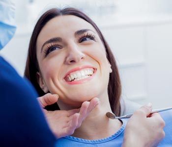 Young woman getting her mouth examined