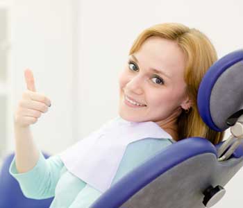 Happy female patient with thumbs up