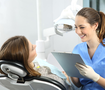 Female patient talking to female hygienist