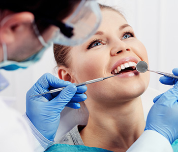 Young woman getting her mouth examined