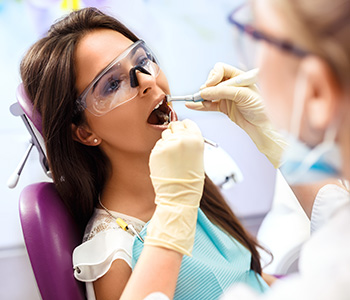 Female patient getting her teeth cleaned