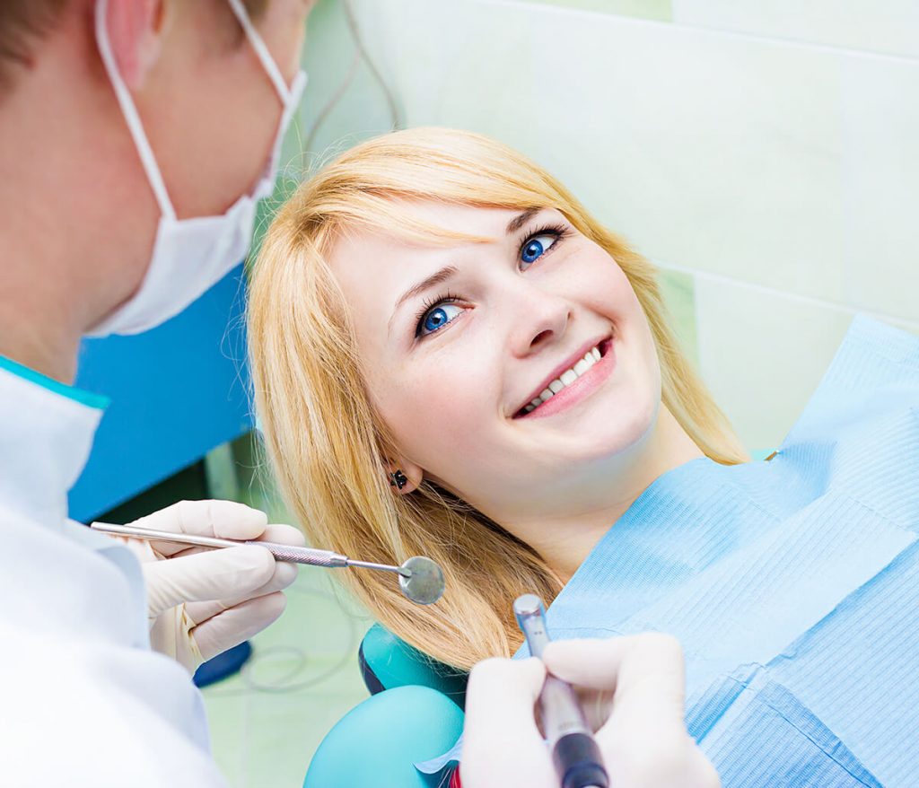 Young woman getting her teeth examined