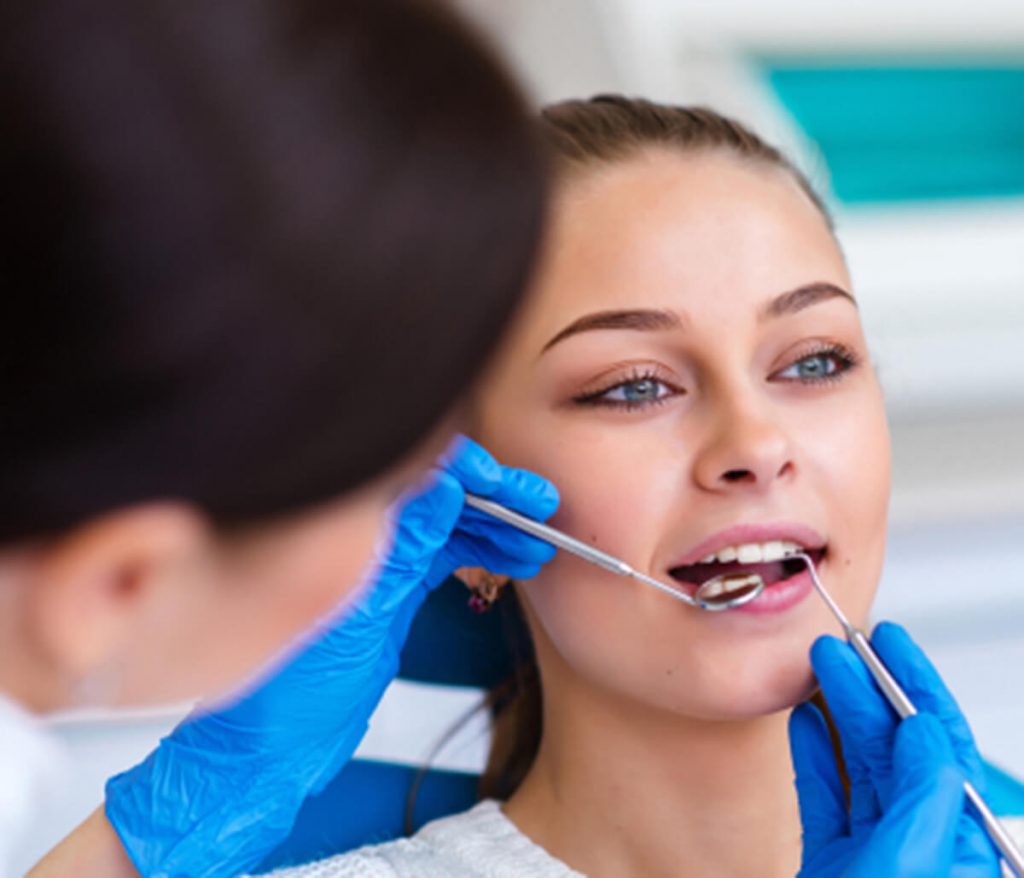 Young woman getting her mouth examined