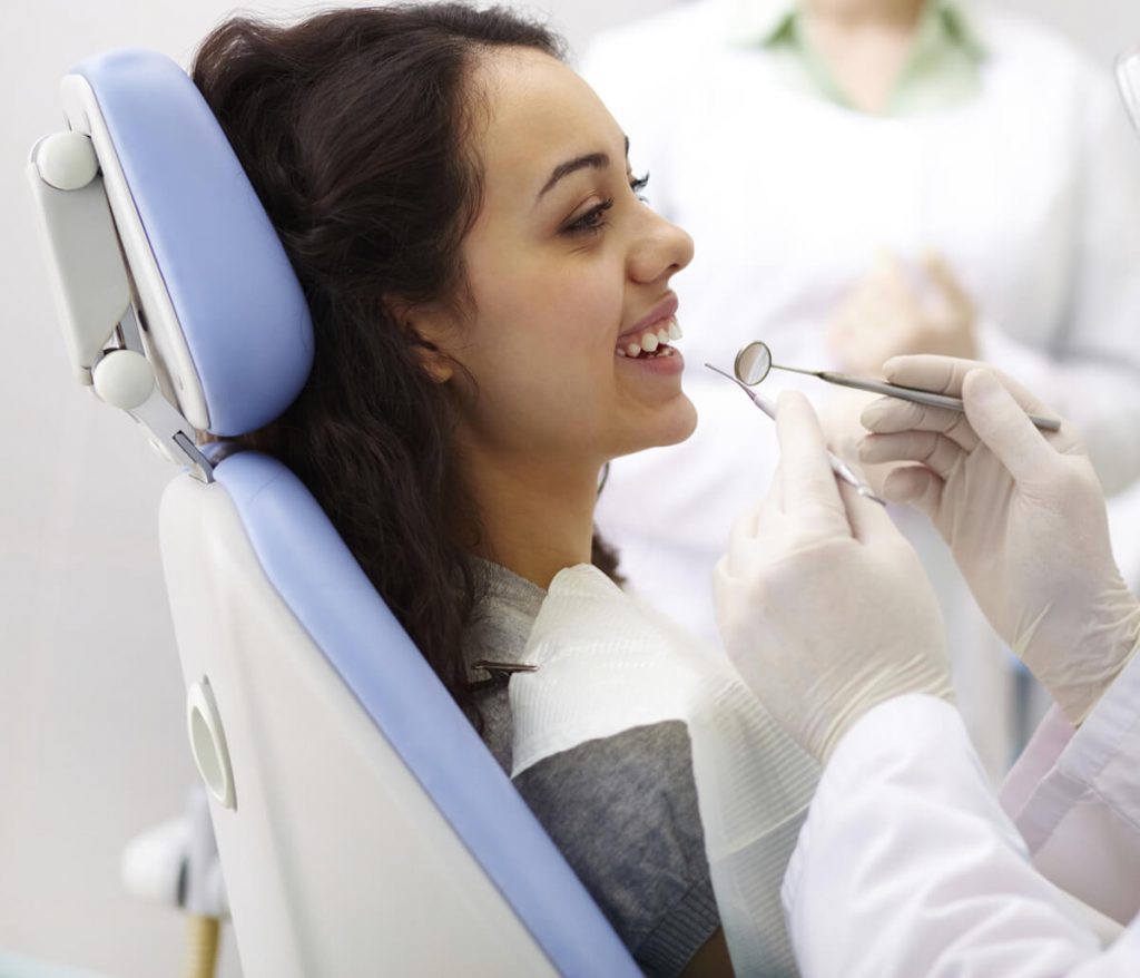 Young woman getting her mouth examined