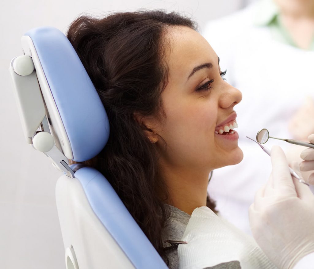 Young woman getting her mouth examined