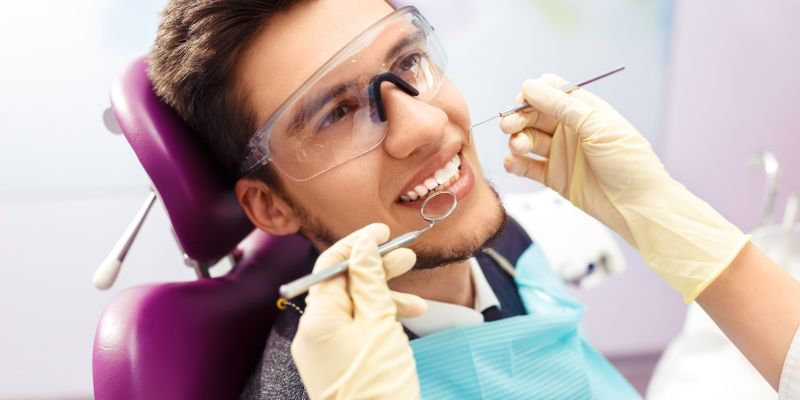 man getting teeth looked at by dentist